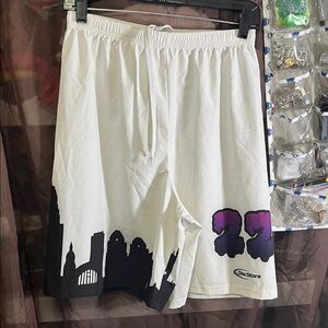 White Athletic Shorts with Black Skyline Graphic and Purple '22 Accent